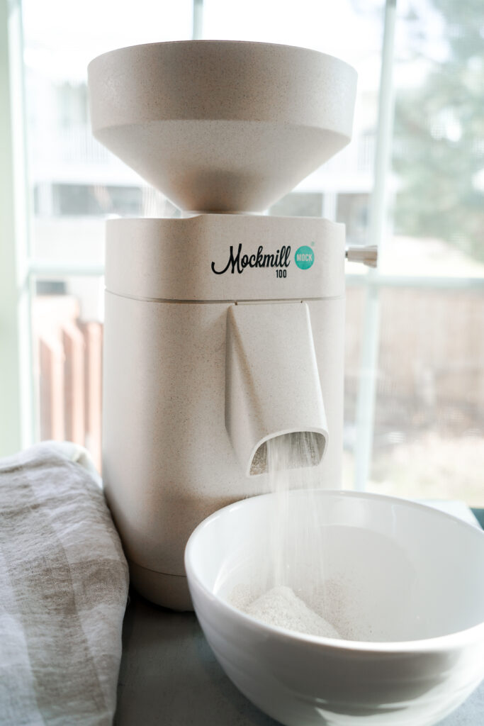 Mockmill 100 grain mill milling wheat berries into freshly milled flour